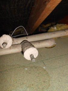Older style cotton cased glass fibre pipe insulation